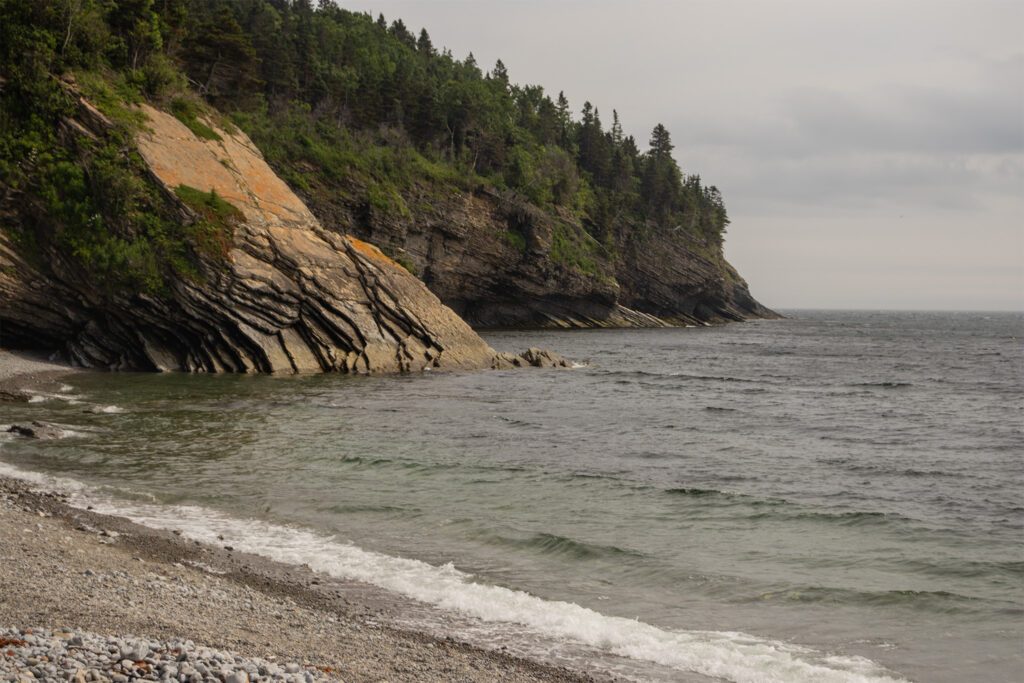 picture of a beach surrounded by a mountain